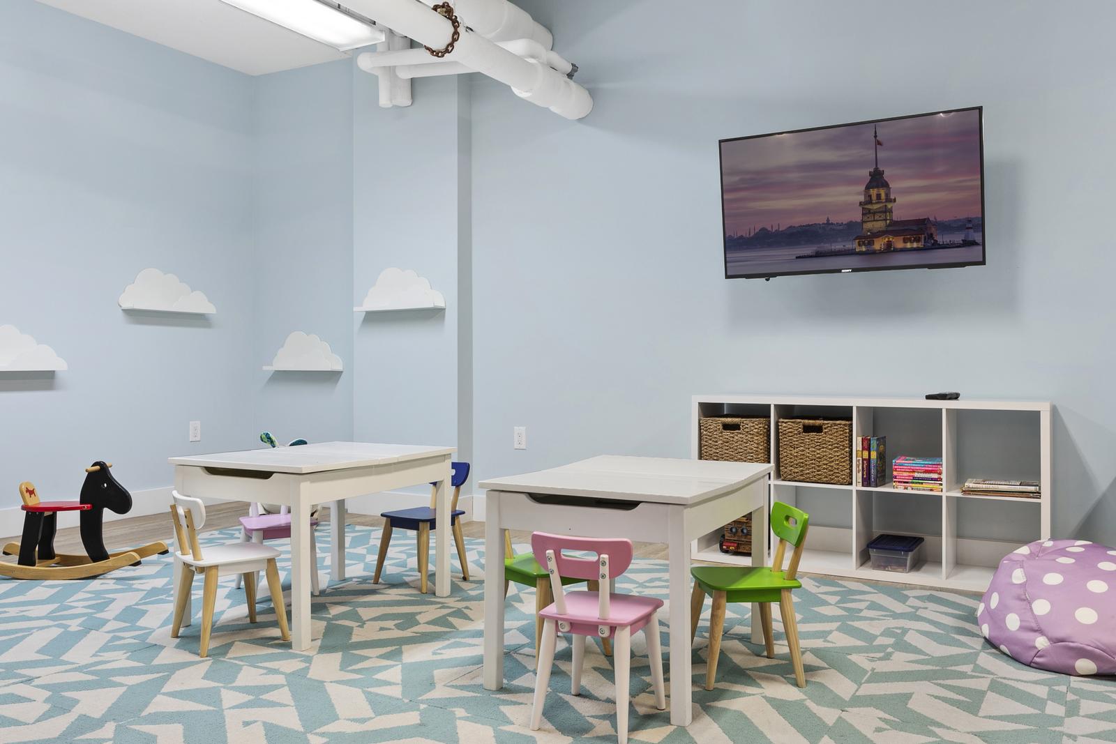 Modern Playroom with Television, Desks, Seating and Cubbies